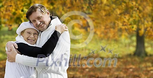 Senior couple hugging in autumn park