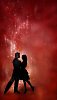 Silhouette of a dancing couple in glittering red background