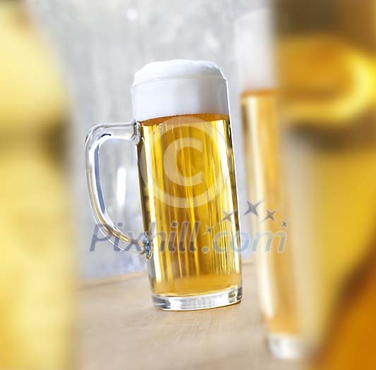One sharp draft beer surrounded by blurred draft beers One sharp draft beer surrounded by blurred draft beers