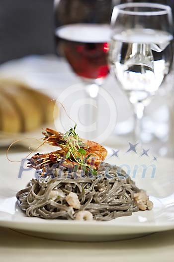 Exotic black pasta with sea food in restaurant