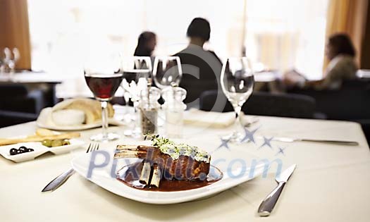 General view of restaurant, lamb carré meal in foreground General view of restaurant, lamb carré meal in foreground