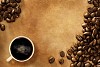 Coffee and coffee beans on a stylish brown background