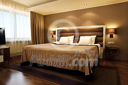 Brown twin bed in a modern hotel room