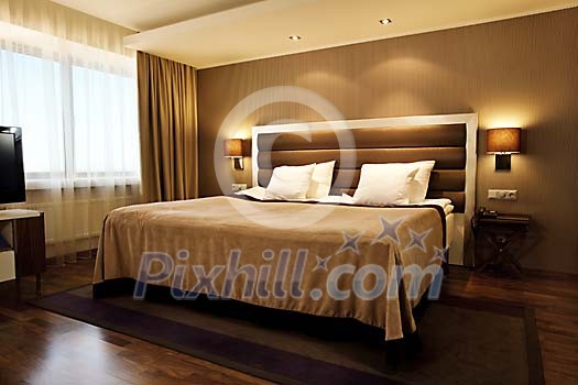Brown twin bed in a modern hotel room Brown twin bed in a modern hotel room