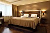 Brown twin bed in a modern hotel room
