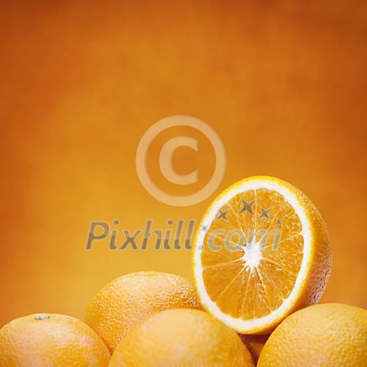 Group of fresh oranges on orange background
