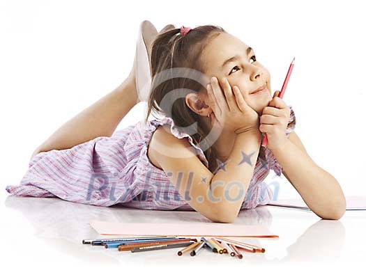 Young girl lying on floor with color pencils