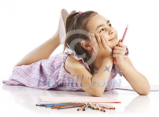 Young girl lying on floor with color pencils Young girl lying on floor with color pencils