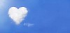 Lonely cloud in shape of heart on blue sky