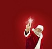 Santa Claus touching a magic Christmas star