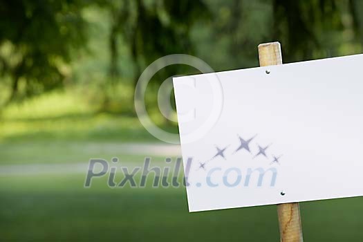 Empty sign on a green yard