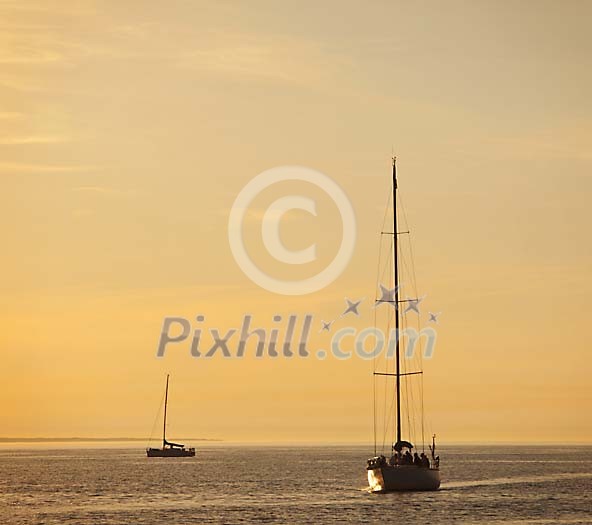 Two boats on the sea at sunset