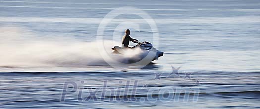 Man speeding on a jet ski Man speeding on a jet ski