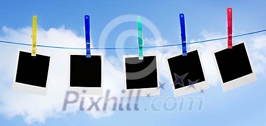 Empty polaroids hanging on washing line