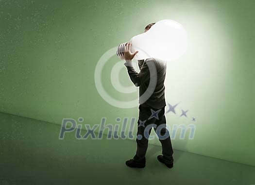 Man carrying oversized lightbulb