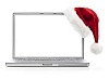 Laptop with santas hat on a white background