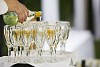Tray of champagne glasses being filled