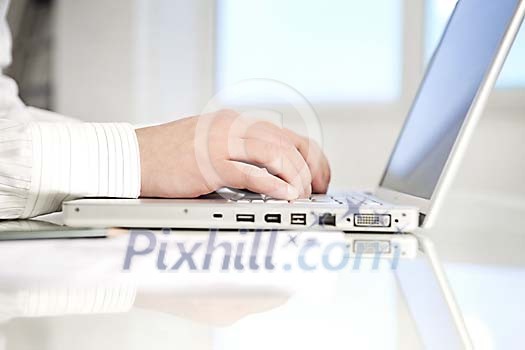 Hands typing on a laptop Hands typing on a laptop