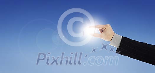 Man holding the sun between his fingers Man holding the sun between his fingers