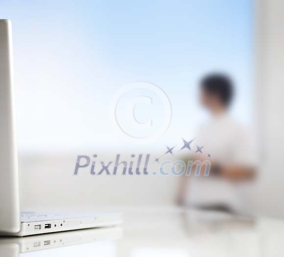 Out of focus man standing by the window Out of focus man standing by the window