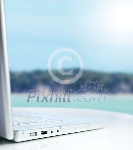Laptop on a table outside on a sunny day Laptop on a table outside on a sunny day