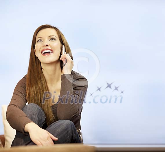 Woman sitting and talking on the phone