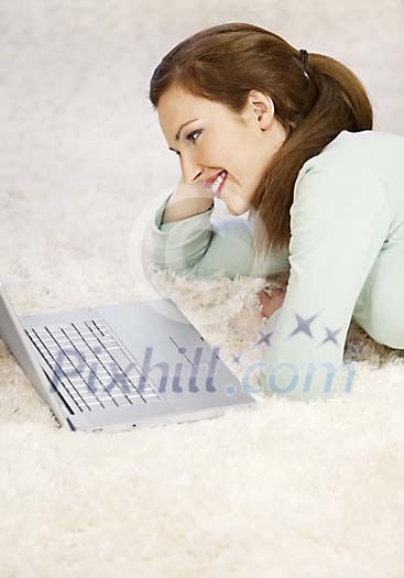 Woman looking at the laptop on the floor