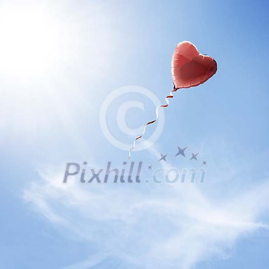 Heart shaped balloon flying in the sky Heart shaped balloon flying in the sky