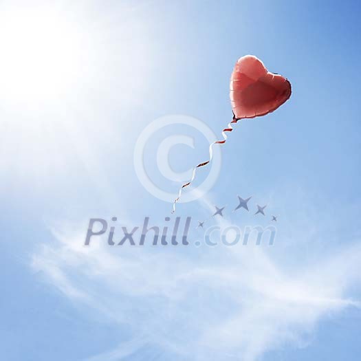 Heart shaped balloon flying in the sky