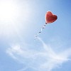 Heart shaped balloon flying in the sky