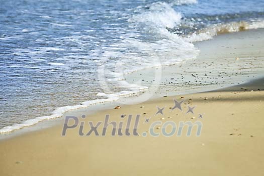 Waves rushing to a sandy beach