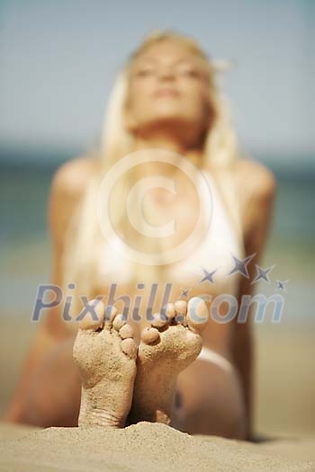 Woman sun tanning at the beach