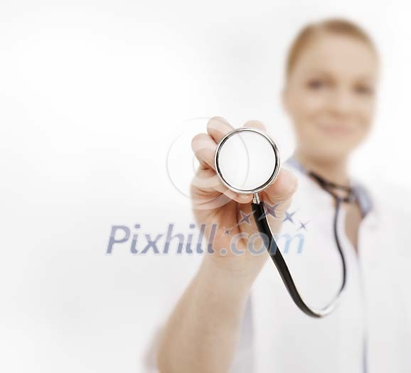 Female doctor holding the stetoscope close to the camera