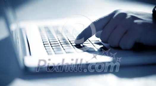 Finger pushing a button on keyboard