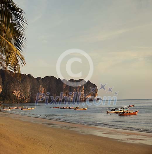 Boats on the shore at the sunset in Ao Nang, Thailand