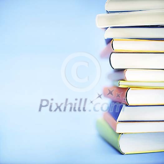 Pile of books on a light blue background