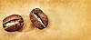 Background of two coffee beans on a brown paper