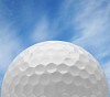 Golfball with a blue sky background