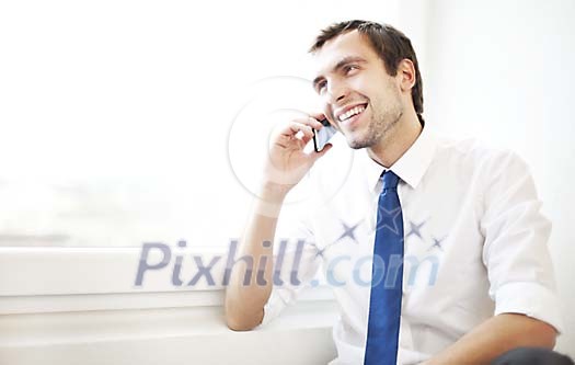 Man smiling while speaking on his cell