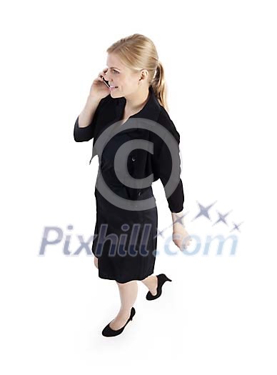 Clipped businesswoman walking and talking to her phone