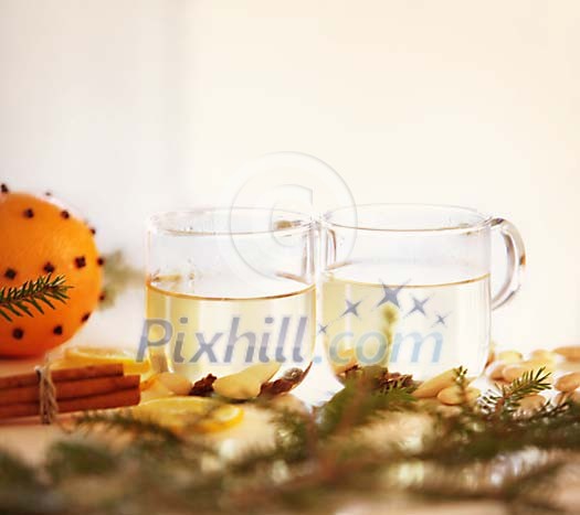 Two cups of white mulled wine with christmas decorations Two cups of white mulled wine with christmas decorations