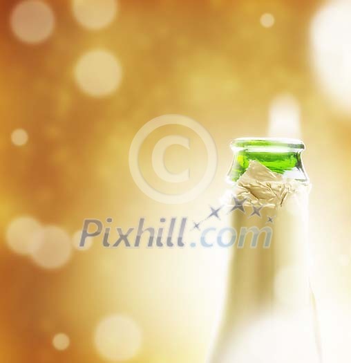 Opened champagne bottleneck on a golden background