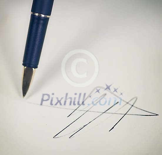Signature being written on a white paper