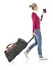 Clipped woman walking with a suitcase and a passport