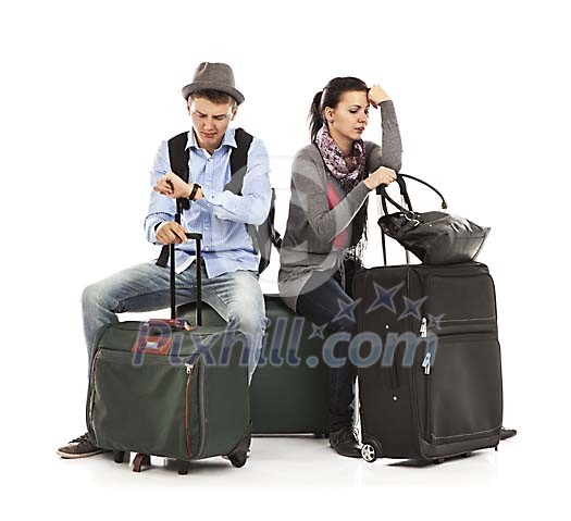 Clipped couple sitting on the luggage and looking frustrated