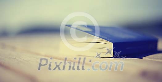Blurry book on a wooden surface Blurry book on a wooden surface