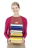 Clipped woman standing with a stack of books and an apple