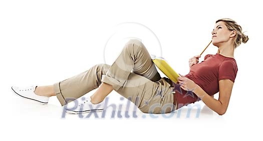 Isolated woman laying on the floor with book, thinking
