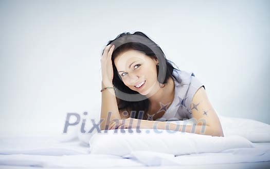 Woman on the bed smiling Woman on the bed smiling