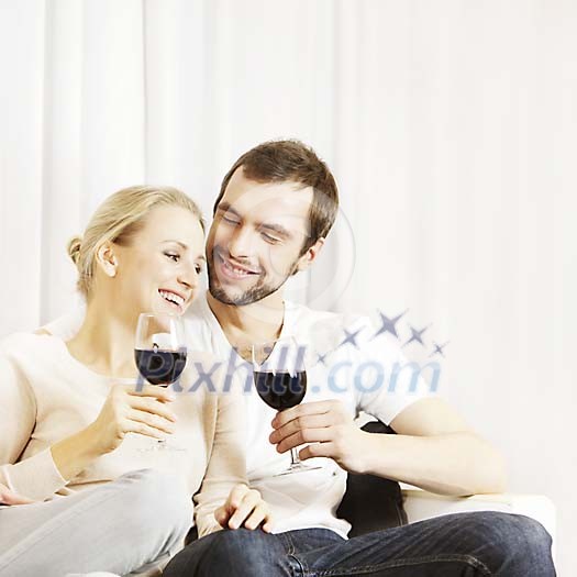 Happy couple sitting and having wine
